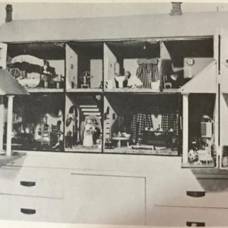 Black and white photo of a dollhouse