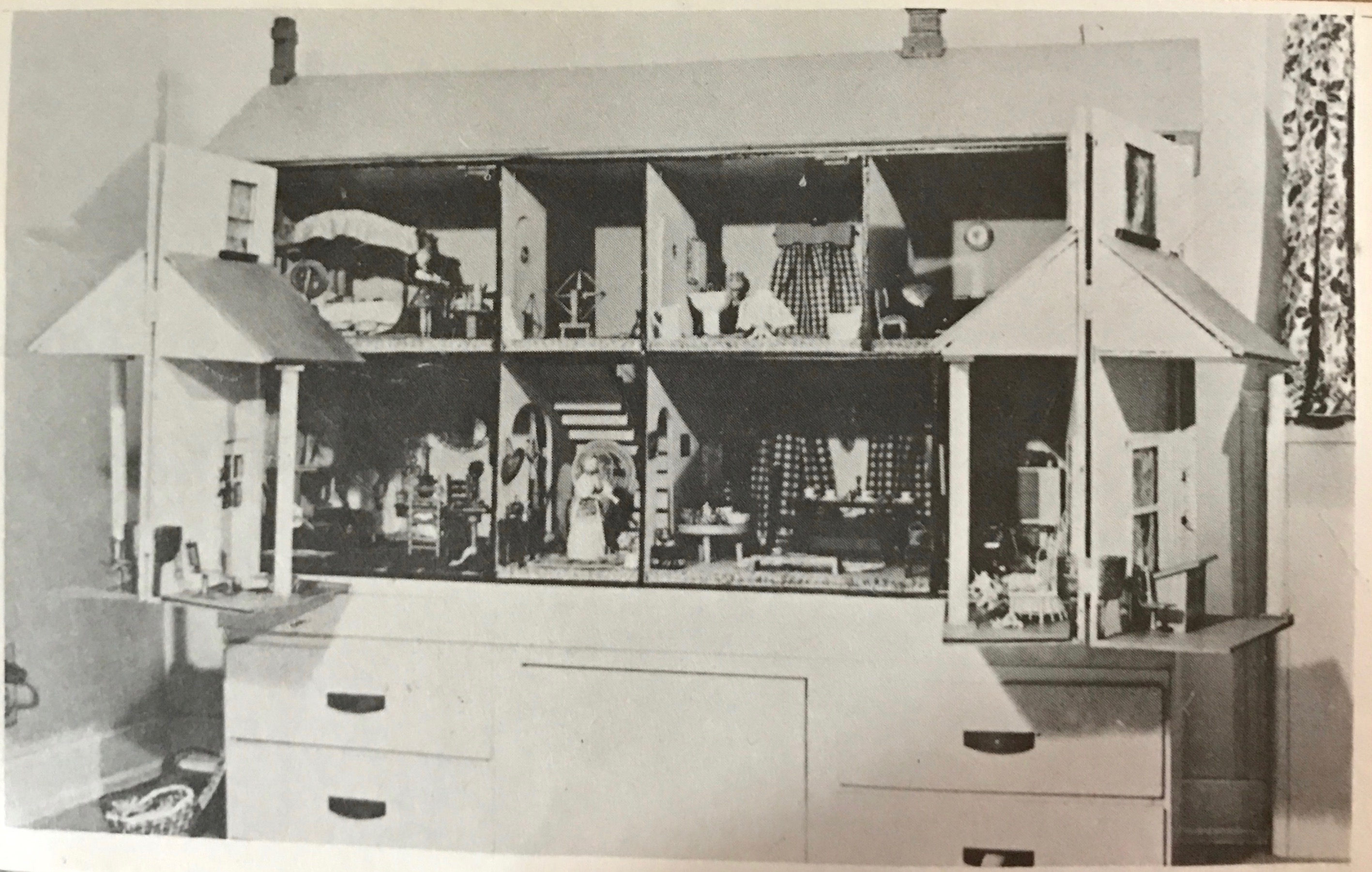 Black and white photo of a dollhouse